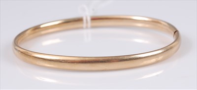Lot 302 - A 9ct gold hinged bangle, undecorated, 6g