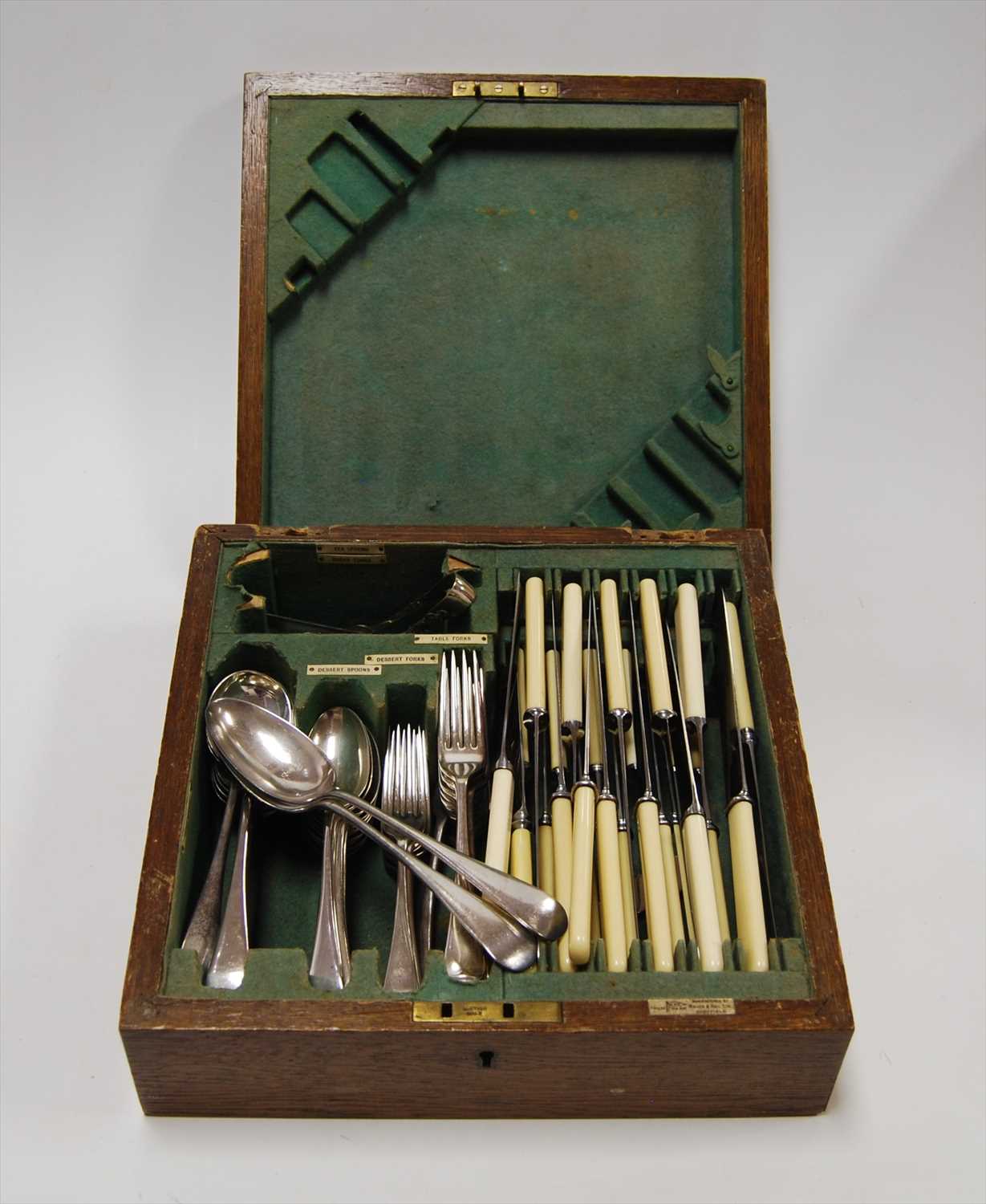 Lot 230 - A 1920s oak cased canteen of silver plated...