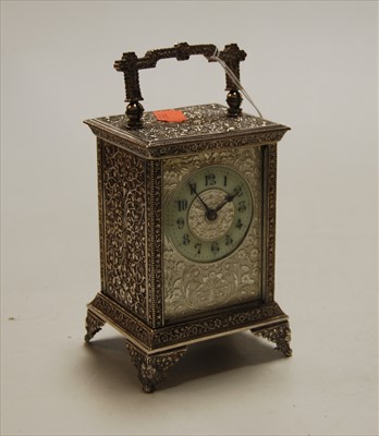 Lot 242 - A white metal cased carriage clock, having...