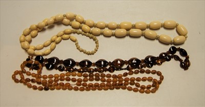 Lot 264 - Two faux amber beaded necklaces together with...