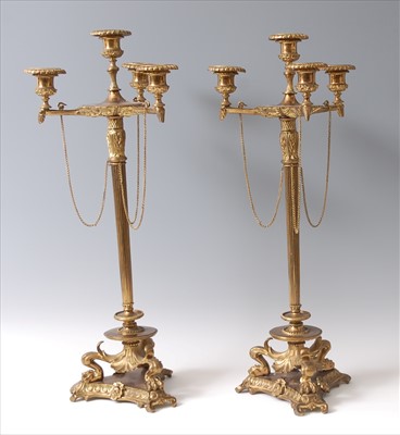 Lot 1289 - A pair of gilt brass four-light candelabra,...