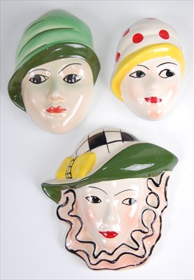 Lot 197 - Three various Crown Devon pottery wall masks,...