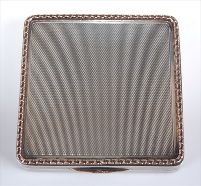 Lot 154 - An Art Deco silver and gold trim pocket...