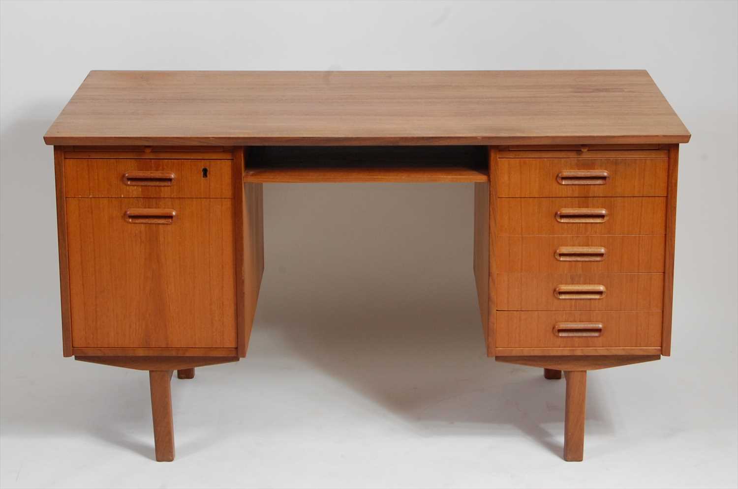 Lot 371 - A 1960s Danish teak kneehole writing desk,...