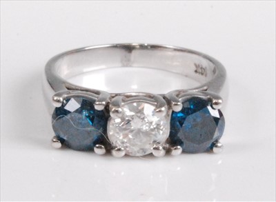 Lot 1195 - A white metal diamond trilogy ring, featuring...