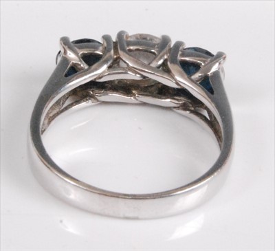Lot 1195 - A white metal diamond trilogy ring, featuring...