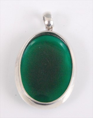 Lot 2081 - A white metal oval moldavite pendant, the...