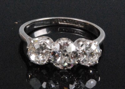 Lot 1197 - A platinum and diamond three stone ring,...