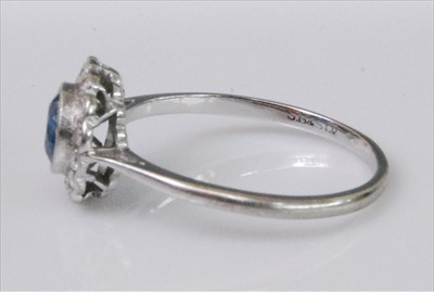 Lot 1219 - A white metal, sapphire and diamond circular...