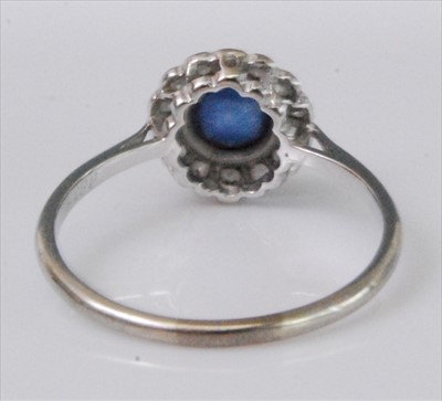Lot 1219 - A white metal, sapphire and diamond circular...