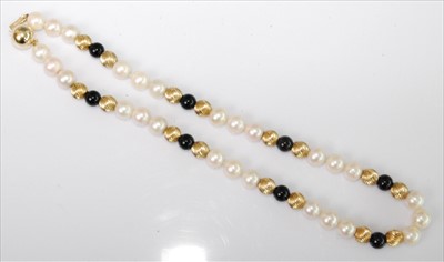 Lot 1233 - A single row pearl necklet, comprising nine...