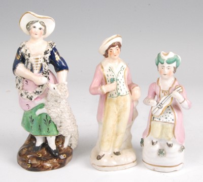 Lot 1127 - A 19th century Staffordshire figure of a lady,...