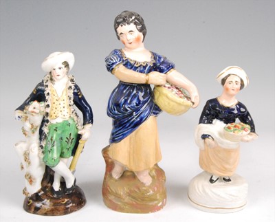 Lot 1128 - A Victorian Staffordshire figure of a lady, in...