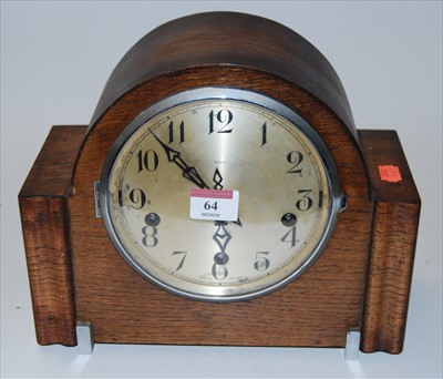 Lot 64 - A 1950s oak cased mantel clock, having a...