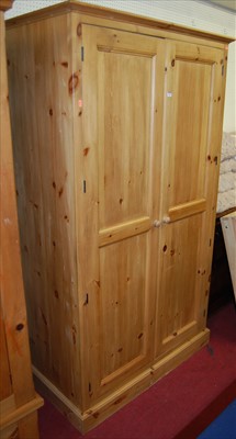 Lot 1105 - A modern pine double door wardrobe, width 112cm