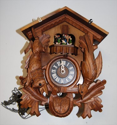 Lot 71 - A modern carved softwood cuckoo clock with...