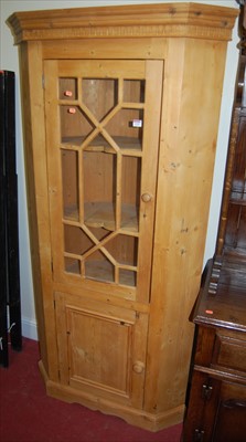 Lot 1135 - A reclaimed pine barrel back corner cupboard,...