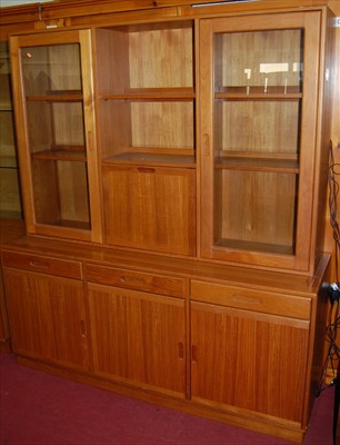 Lot 1140 - A contemporary teak three door side cupboard,...