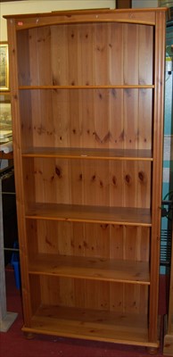 Lot 1144 - A modern pine freestanding open bookshelf,...