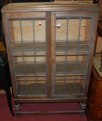 Lot 1152 - A 1930s oak and lead glazed double door...