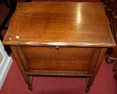 Lot 1171 - A 1930s oak fallfront sewing cabinet, having...