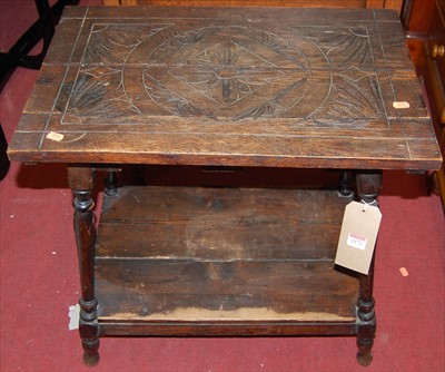 Lot 1172 - An early 20th century line carved oak low...