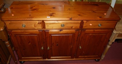 Lot 1173 - A modern pine round cornered three door...