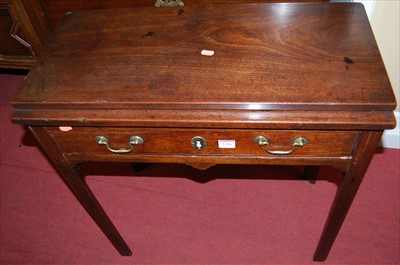 Lot 1186 - A Georgian mahogany fold-over tea table,...