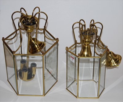 Lot 125 - A near pair of lacquered brass and glass...