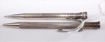 Lot 345 - An engine turned silver propelling pencil;...