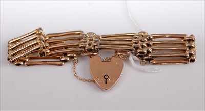 Lot 358 - A 9ct gold gatelink bracelet with heart shaped...