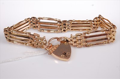 Lot 359 - A 9ct gold gatelink bracelet with heart shaped...