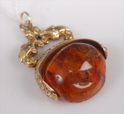 Lot 408 - A pinchbeck and amber swivel fob pendant, with...