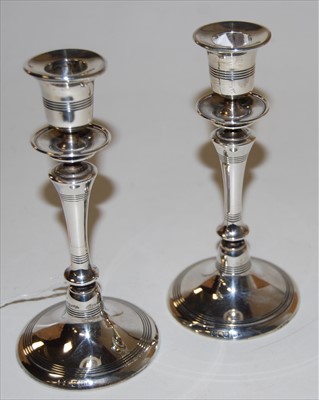 Lot 196 - A pair of George V silver table candlesticks,...