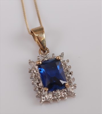 Lot 388 - A 9ct gold synthetic sapphire and diamond...