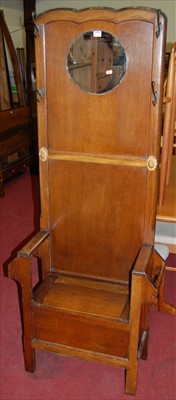 Lot 1219 - A 1930s panelled oak mirrorback hall seat,...