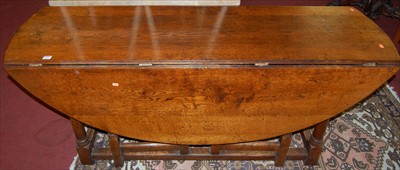 Lot 1222 - A 17th century style joined oak dropleaf wake...