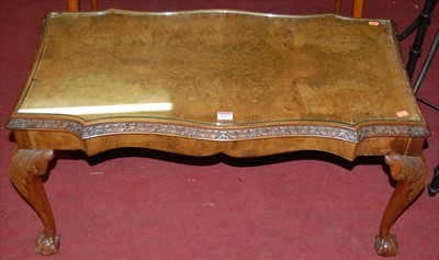 Lot 1243 - A figured walnut and crossbanded shaped top...