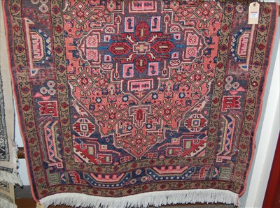 Lot 1128 - A Persian woollen rug, with lozenge shaped...