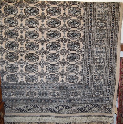 Lot 1129 - A large Persian woollen Bokhara rug, having...