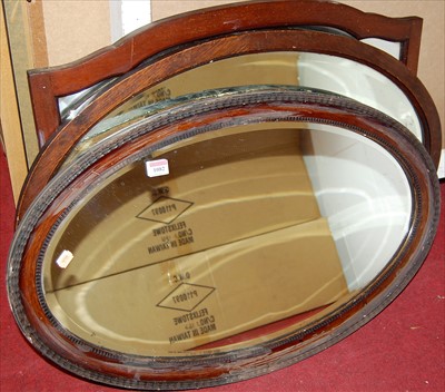 Lot 1082 - An oak framed bevelled oval wall mirror, and...