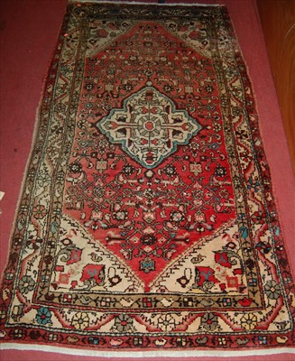 Lot 1280 - A Persian woollen red ground Tabriz rug, 221 x...