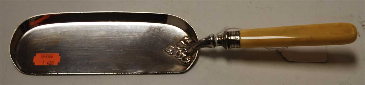 Lot 244 - An Edwardian silver crumb scoop having a faux...