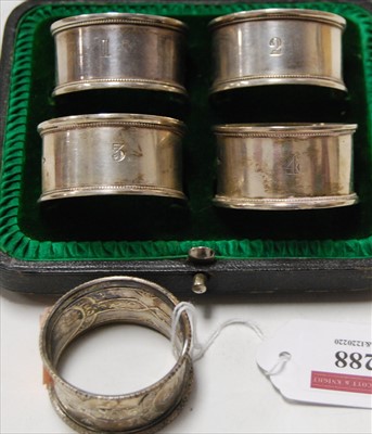 Lot 288 - A set of four George V silver napkin rings, of...