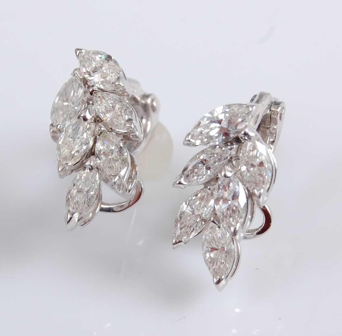 Lot 1236 - A pair of 18ct white gold diamond cluster...