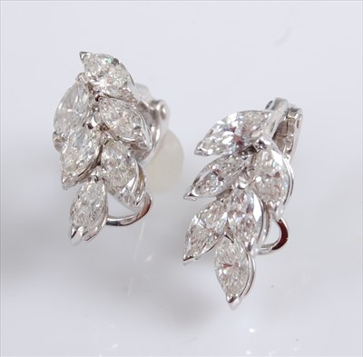 Lot 1236 - A pair of 18ct white gold diamond cluster...
