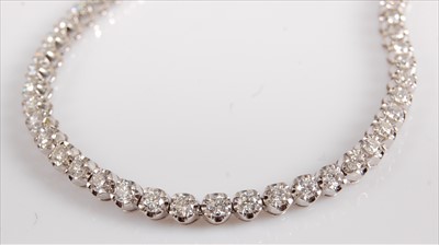 Lot 1222 - A white metal diamond line bracelet,...