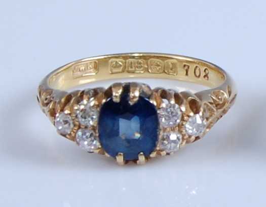 Lot 1239 - An 18ct yellow gold, sapphire and diamond ring,...
