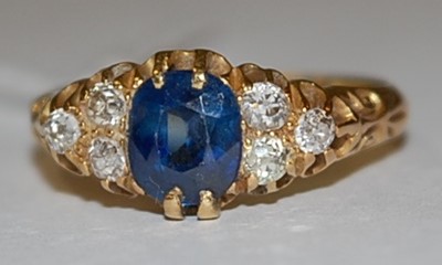 Lot 1239 - An 18ct yellow gold, sapphire and diamond ring,...