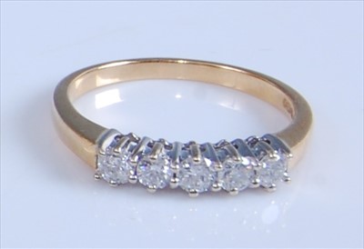 Lot 1242 - An 18ct yellow and white gold five-stone...